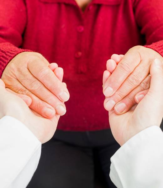 Young carer giving helping hands for elderly woman